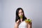 Asian woman confused with eating salad isolated over white background