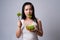 Asian woman confused with eating salad isolated over white background