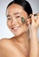 Asian woman, cosmetics and facial roller for wellness, skincare and smooth face with studio background. Young female