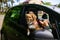 Asian Woman And Cute Dog In Car On Summer Travel