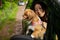 Asian Woman And Cute Dog In Car On Summer Travel