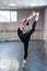 Asian woman dancing in ballet class doing bilman pose.