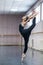 Asian woman dancing in ballet class doing bilman pose.