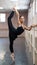 Asian woman dancing in ballet class doing bilman pose.