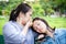 Asian woman is dissatisfied with the smell of her daughter`s hair,bad smell,child girl is taking a nap near her mother, mom