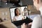 Asian woman and diverse colleagues taking part in group videocall