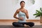 Asian woman doing breathing exercise before practice yoga.Healthy female inhaling and exhaling to deep breath exercise for control