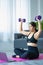 Asian woman doing shoulder stretching yoga at home in living room, fitness fit yoga for good health.