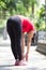 Asian woman doing stretching exercise during outdoor cross train