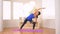 Asian woman doing yoga pose: extended side angle