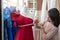 Asian woman dressmaker fashion designer measuring size of mannequin in showroom. Concept of dressmaking and fashion