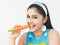 Asian woman eating a carrot