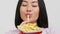 Asian Woman Eating French Fries Enjoying Junk Food, White Background