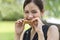 Asian woman eating with whole wheat sandwich bread with chocolate sauce