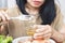 Asian woman eats raw shrimp,  uncooked seafood could get sick from food poisoning