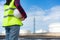 Asian woman engineer holding a white safety helmet with oil refinery tank plant factory in background with blue sky