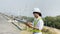 Asian woman engineers are checking and submitting reports outdoors on site power plant energy