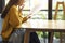 Asian woman so excited work and holding document, glad of working success and achieve, sitting alone at cafe