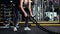 Asian woman exercise and solo lifestyle at fitness gym. Sporty woman workout alone with Battle rope. Wellness and healthy