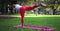 Asian woman exercising yoga in a park