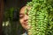 Asian woman with exotic dischidia houseplants