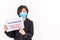 Asian woman with face mask holding placard with Social Distancing, Keep Your Distance message