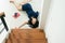 Asian woman falling down of staircase and having injured at home