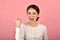 Asian woman feeling happy and excited on accomplish success on pink background.