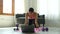 Asian woman fitness trainer conducting virtual yoga class with group of people at home on a video conference. Fitness