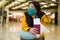 Asian woman flying in covid19 times - lifestyle portrait of young beautiful and tired Chinese girl in face mask waiting on airport