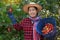 Asian woman gardener works at cashew garden