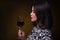 Asian woman with glass of red wine