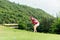 Asian woman golfer action to win after long putting golf ball on the green golf.