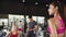 Asian woman greet Caucasian friend exercising with male personal trainer in fitness gym or sport club. Recreational activity