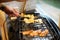 Asian Woman Grilling mushroom at a kitchen home, Blurred soft.