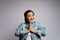 Asian woman guilty holding hands in prayer standing isolated over white background