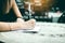 Asian woman hand checking shopping list on desk at outside outlet mall