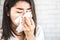 Asian woman hand holding tissue sneezing having fever and flu