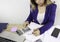 Asian woman hand with pen  check calculating her monthly of debt bills bank papers expenses and payment