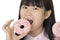 Asian woman having some fun with delicious strawberry frosted do