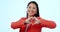 Asian woman, heart sign and studio for smile, face or love icon for review by blue background. Japanese business person