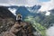 Asian woman hiker and traveller walking on narrow ridge of Romsdalseggen hiking trail, Norway, Scandinavia