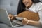 Asian woman holding credit cart and using laptop to shopping online.