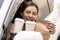 Asian woman holding food bag from drive thru service restaurant