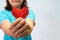 An asian woman holding heart origami in front of her chest. A woman giving red heart paper to someone. Love and give concept for v