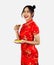 Asian woman holding plate of teas in red traditional oriental costume. Chinese new year concept style