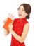 Asian woman holding a red envelope with money