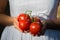 Asian woman holding red tomatoes