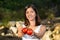 Asian woman holding red tomatoes