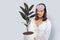 Asian woman holding rubber plant